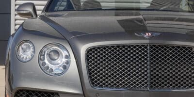 A front view showcasing the grill of a stunning silver 2024 Bentley, with a keen eye on the 2024 Bentley Price