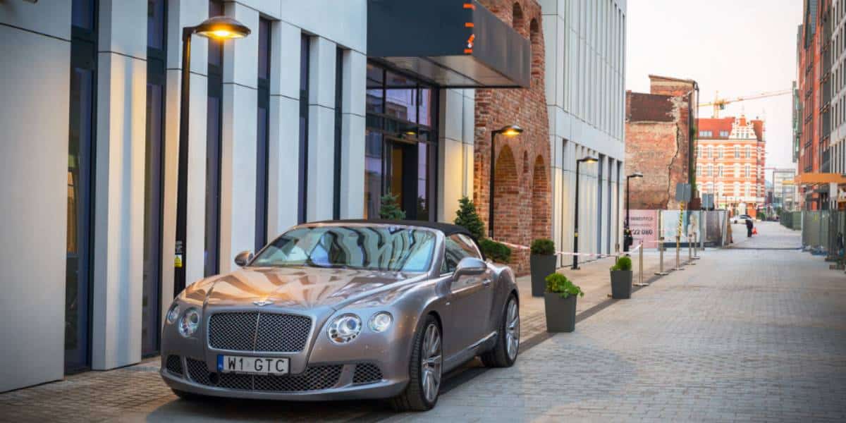 The Bentley Convertible parked outside of a store.