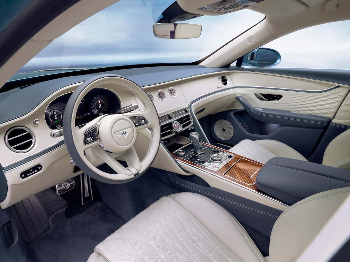 Luxurious interior of the Bentley Azure with quilted leather seats, wood trim, and premium controls.